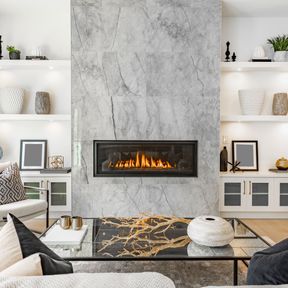 lounge scene with modern marble fireplace and glass coffee table